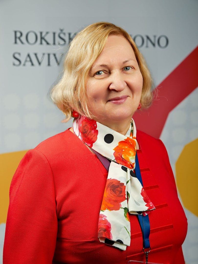 Zita Čaplikienė negalios koordinatorė, šviesių trumpų plaukų besišypsanti moteris su raudonu ir gelėta skarele ant kaklo